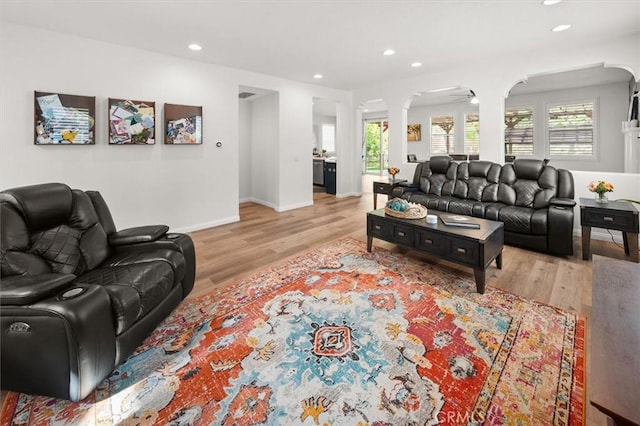 living room featuring light wood-type flooring, a wealth of natural light, and recessed lighting