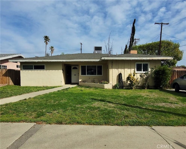 ranch-style home with a chimney, fence, a front lawn, and stucco siding