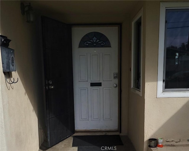 entrance to property with stucco siding