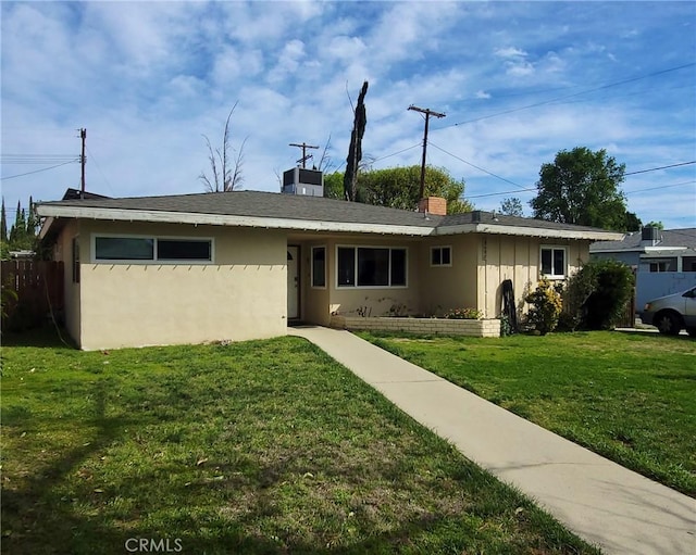 ranch-style home with a front yard and stucco siding