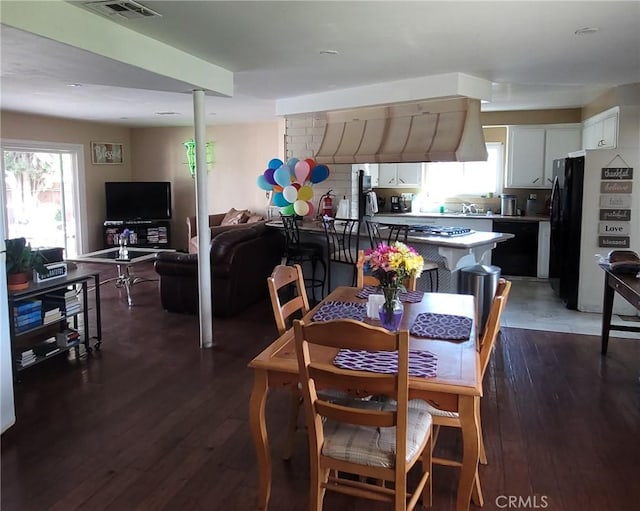 dining area with visible vents and dark wood-style flooring