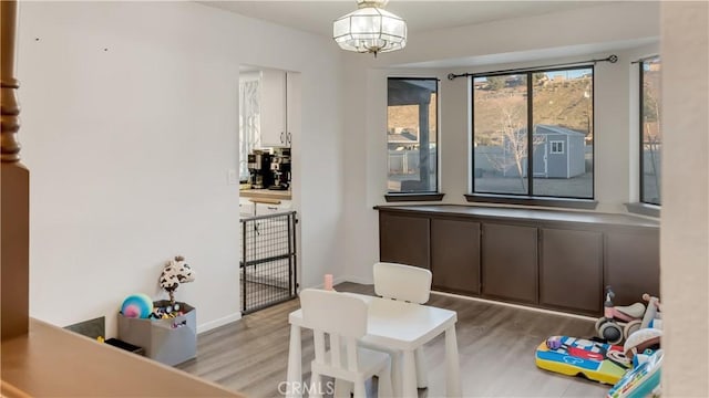 interior space with baseboards and wood finished floors