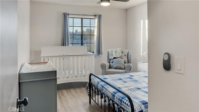 bedroom with a ceiling fan and wood finished floors