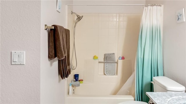 full bath with toilet, a textured wall, shower / bath combo with shower curtain, and vanity