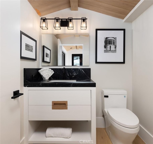 bathroom featuring toilet, vaulted ceiling, vanity, wood finished floors, and wooden ceiling