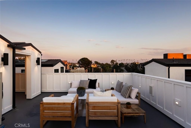 patio terrace at dusk featuring outdoor lounge area