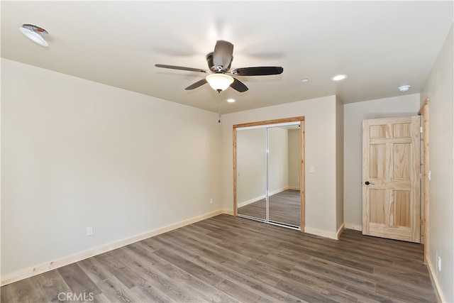 unfurnished bedroom with a closet, baseboards, and wood finished floors