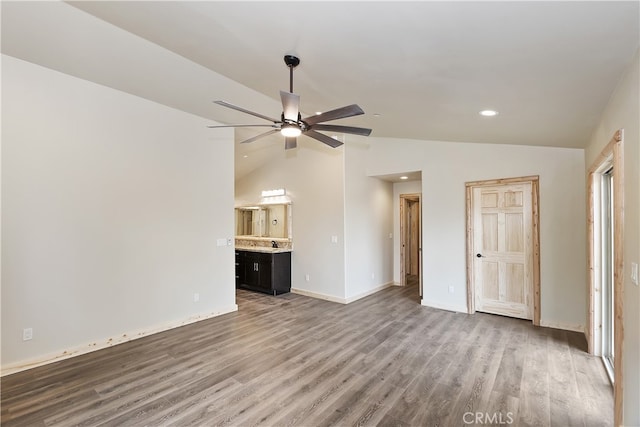 interior space featuring baseboards, a ceiling fan, wood finished floors, high vaulted ceiling, and recessed lighting