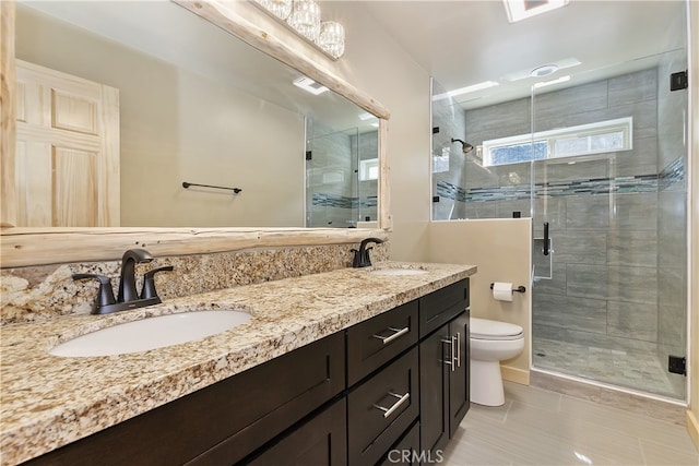 bathroom with a stall shower, a sink, and toilet