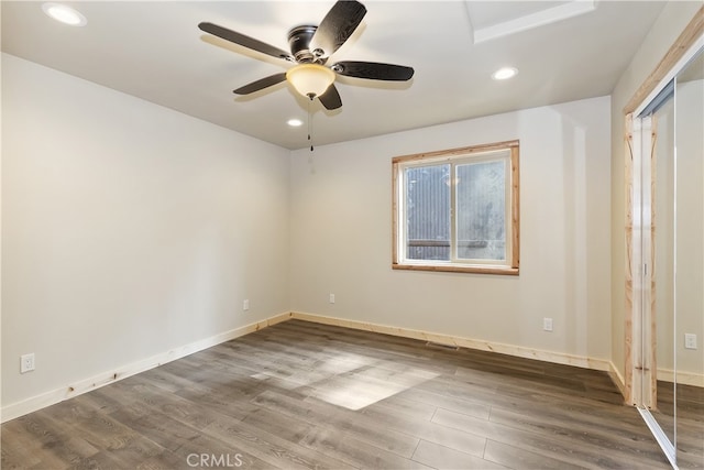 empty room with baseboards and wood finished floors