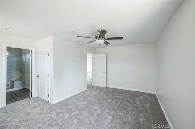 unfurnished bedroom with ensuite bathroom, carpet floors, and baseboards