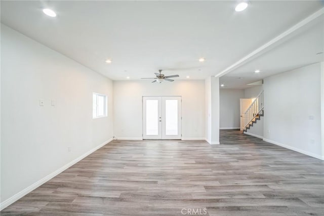 interior space featuring recessed lighting, french doors, wood finished floors, and stairs