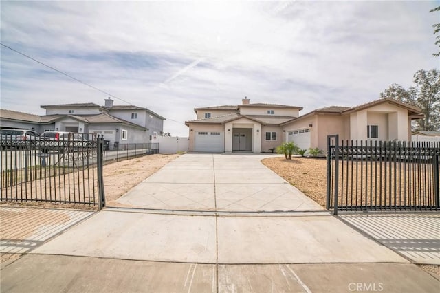 view of front of property with stucco siding, concrete driveway, a garage, a fenced front yard, and a tiled roof