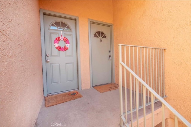 property entrance with stucco siding