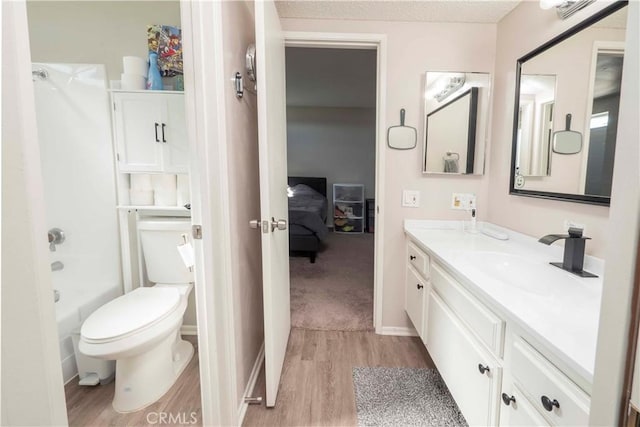 full bathroom featuring  shower combination, vanity, toilet, and wood finished floors