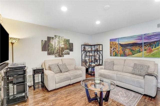 living area with recessed lighting and wood finished floors