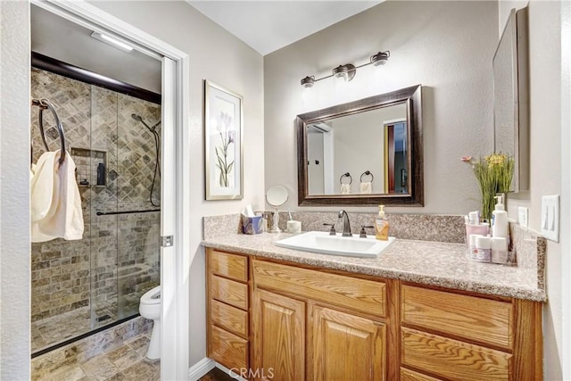 full bath featuring a stall shower, toilet, and vanity