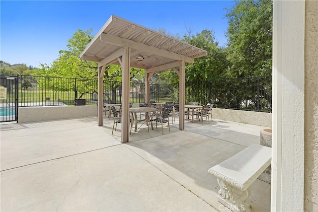 view of patio featuring outdoor dining area, fence, and a pergola