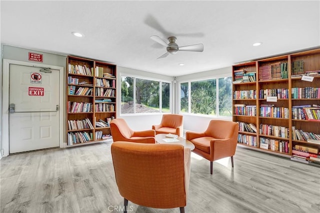 living area featuring wood finished floors, a ceiling fan, and recessed lighting