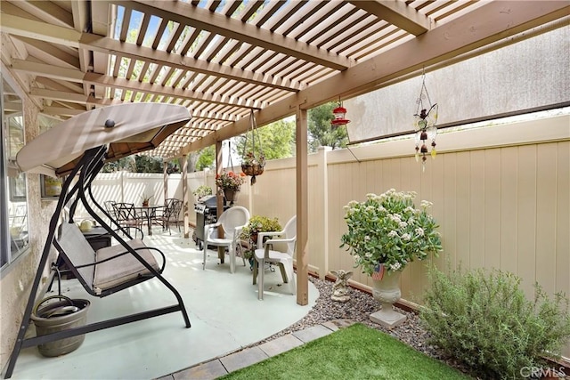 view of patio with outdoor dining area, a fenced backyard, and a pergola