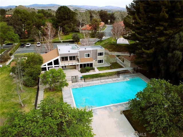 pool with a patio area and a mountain view