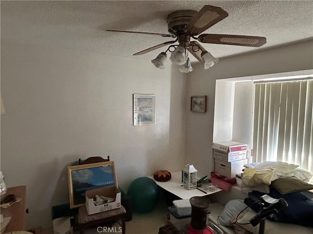 unfurnished bedroom with ceiling fan and a textured ceiling