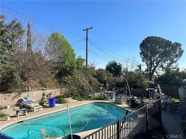 view of swimming pool with a fenced in pool, fence, and a patio