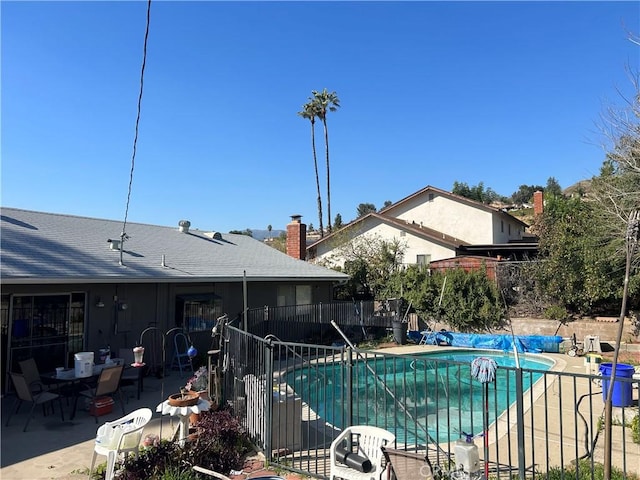 view of swimming pool featuring a fenced in pool, a patio area, and fence