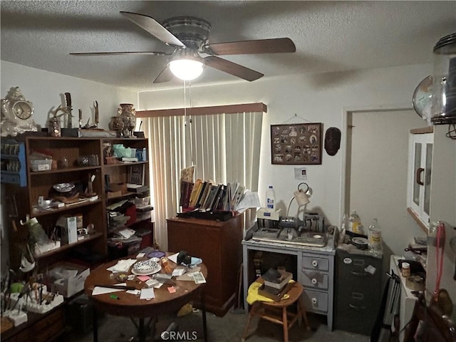 misc room with ceiling fan and a textured ceiling