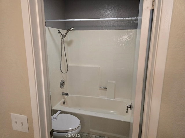 bathroom with toilet and washtub / shower combination