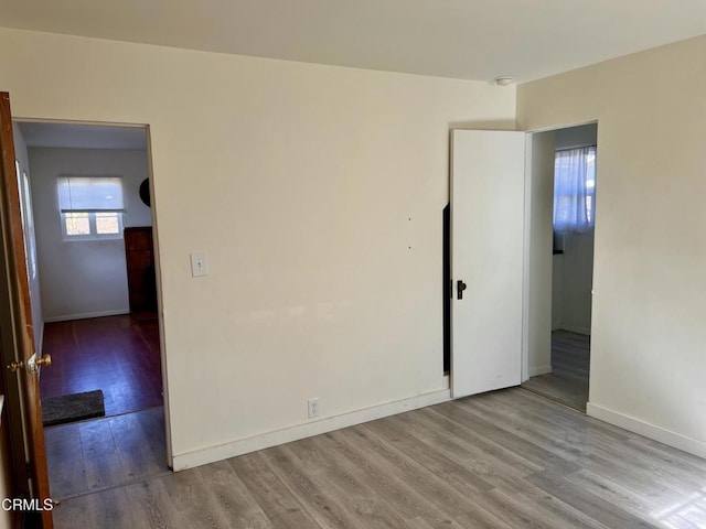 empty room featuring baseboards and wood finished floors