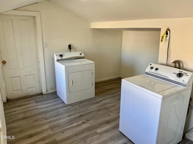 washroom with laundry area, separate washer and dryer, wood finished floors, and baseboards