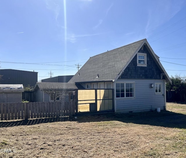 back of house featuring fence