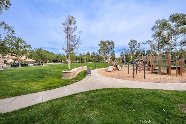 view of community featuring playground community and a yard