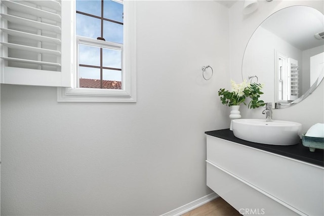 bathroom with baseboards and vanity