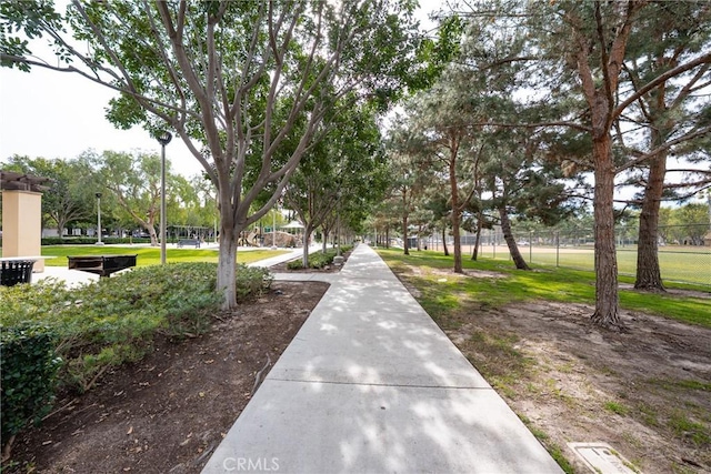 view of property's community featuring fence and a yard