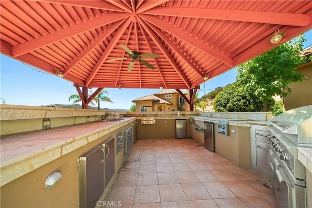 view of patio with a gazebo, area for grilling, and a sink