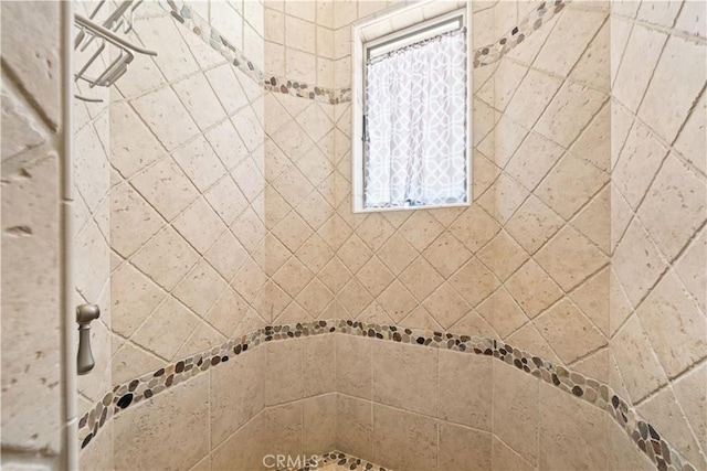 full bath with a tile shower