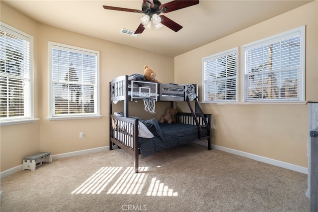 bedroom featuring a ceiling fan, carpet, visible vents, and baseboards