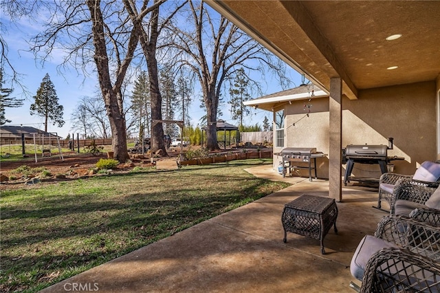 view of yard with a patio area, fence, and a gazebo