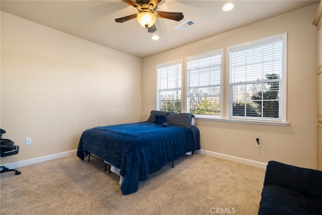 bedroom with light colored carpet, visible vents, baseboards, and recessed lighting