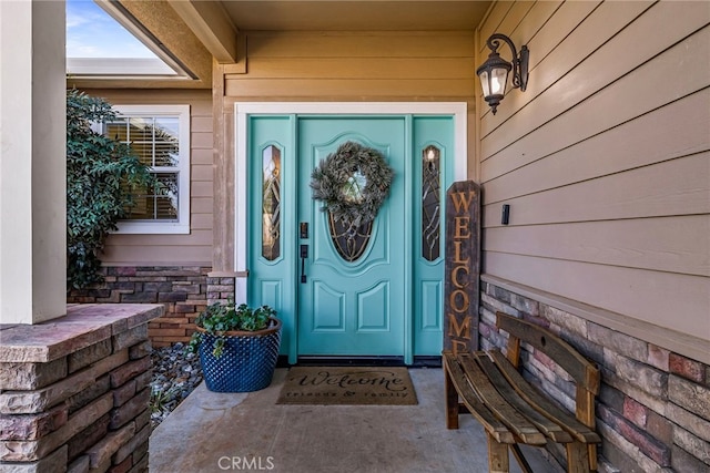 property entrance featuring stone siding