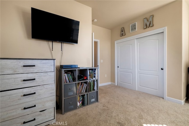 bedroom featuring carpet floors, a closet, and baseboards