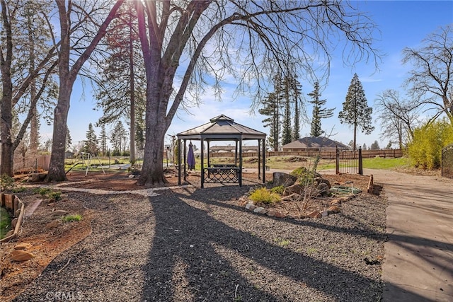 view of home's community with fence and a gazebo