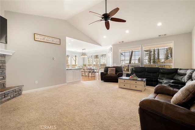 living area with light carpet, a fireplace, visible vents, baseboards, and vaulted ceiling