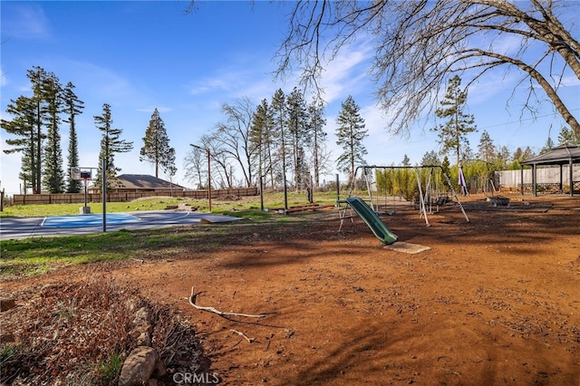 community jungle gym featuring community basketball court and fence