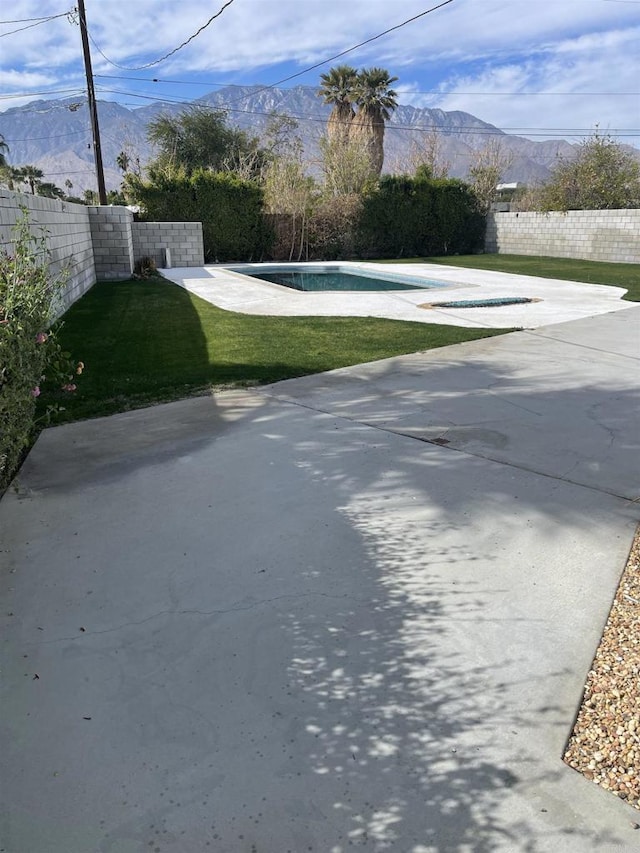 view of street featuring driveway and a mountain view