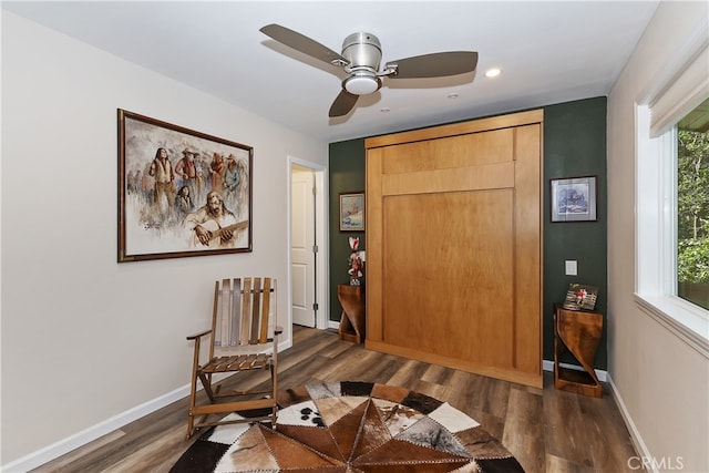 sitting room featuring baseboards and wood finished floors