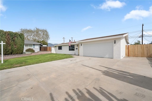 ranch-style home with a garage, concrete driveway, stucco siding, fence, and a front yard