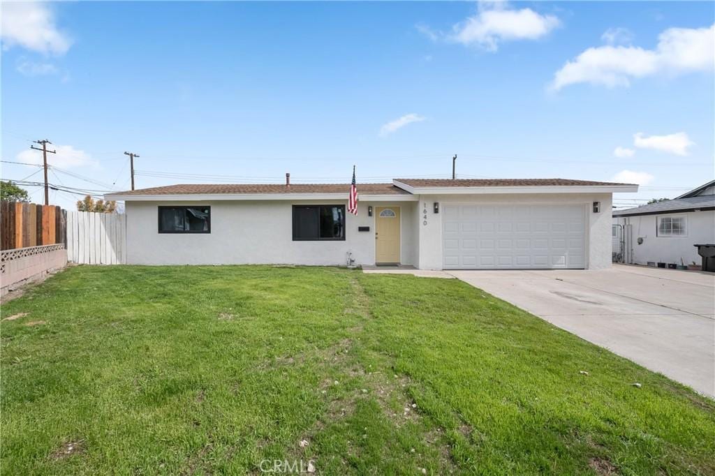 single story home with driveway, a garage, stucco siding, fence, and a front yard